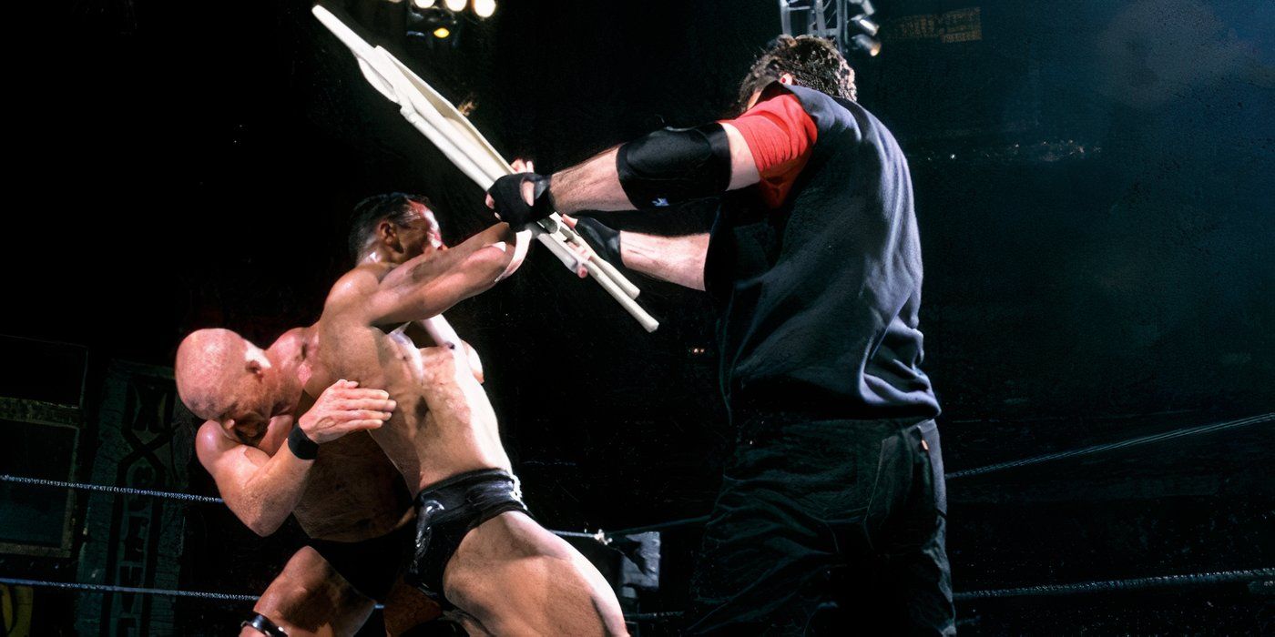Stone Cold Steve Austin helps Mr. McMahon hit The Rock with a steel chair at WWE WrestleMania X-Seven