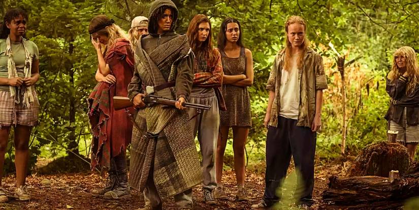 Taissa holding a gun while the teens look horrified in Yellowjackets season 3.