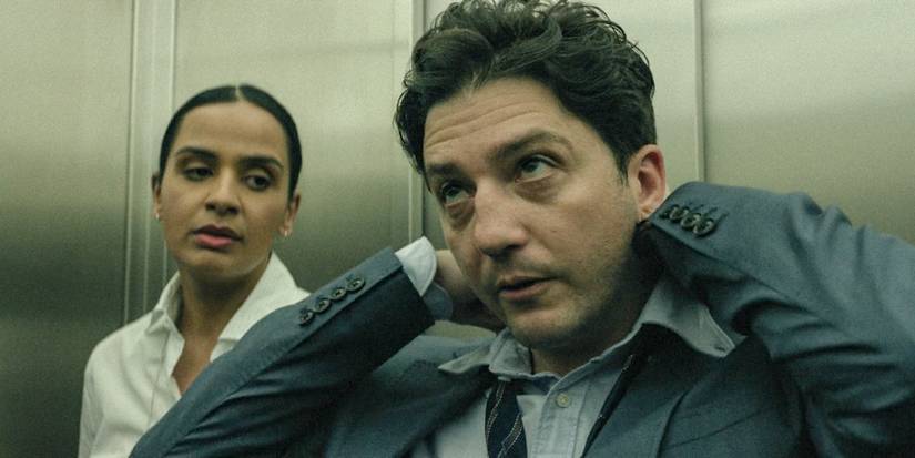 Owen Taylor (John Magaro) in an elevator with a woman in The Agency