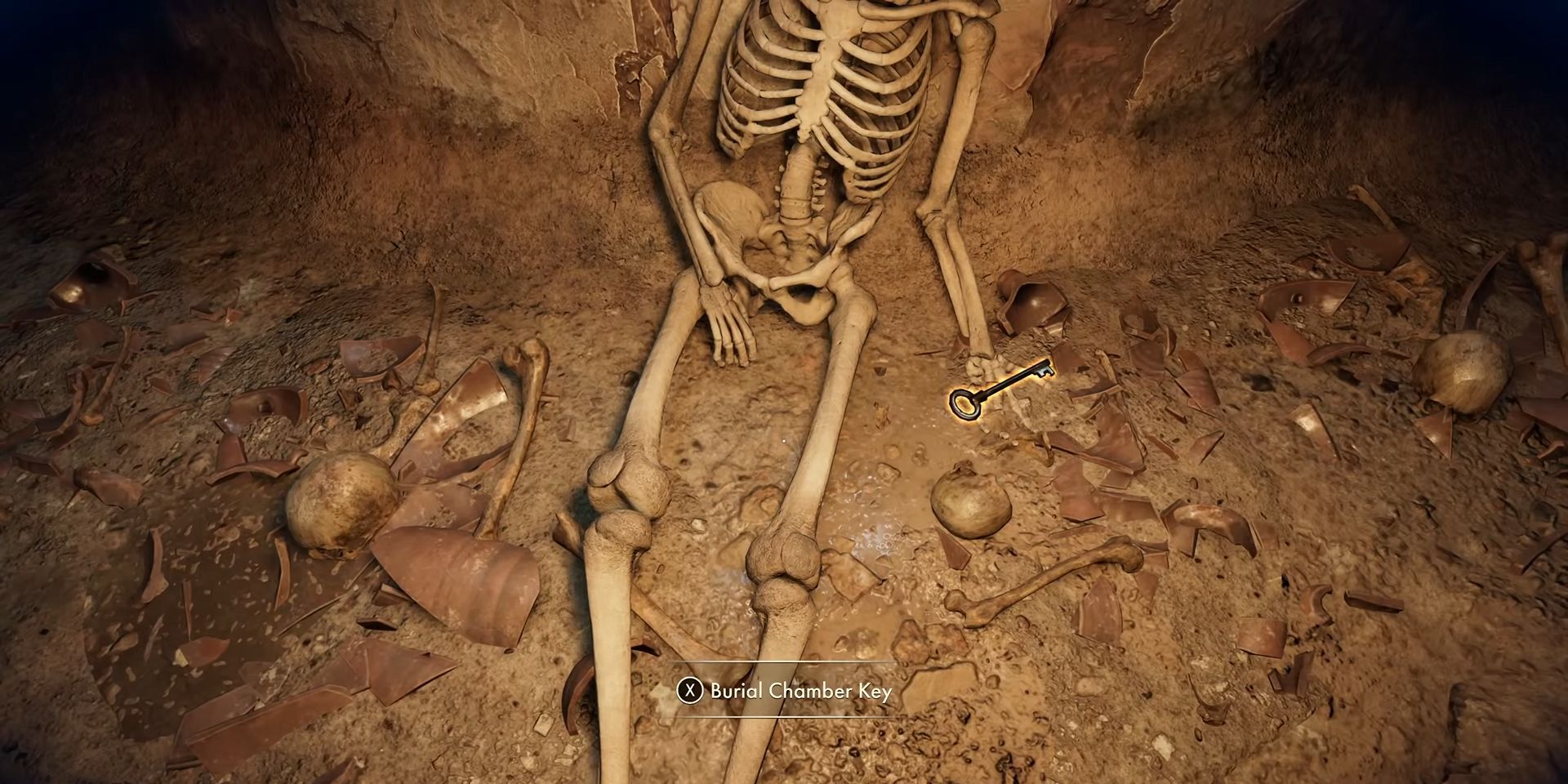 The burial chamber key lying on the floor next to a skeleton in Indiana Jones and the Great Circle.