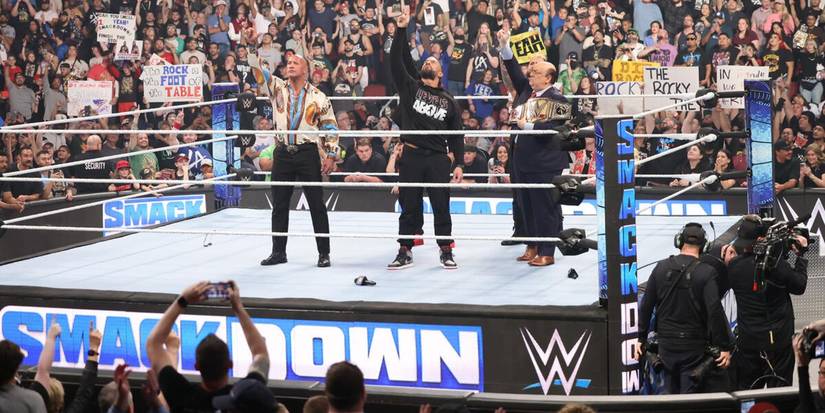 The Rock Roman Reigns Solo Sikoa Jimmy Uso and Paul Heyman of the Bloodline throw up the ones on WWE Friday Night SmackDown