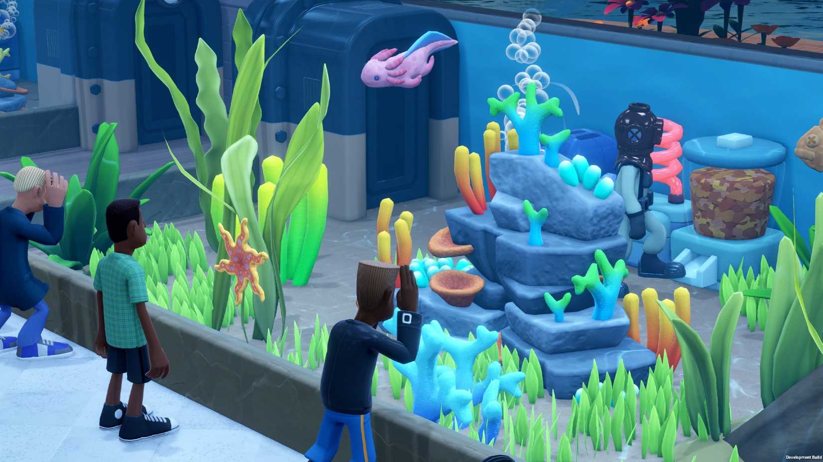 Two Point Museum aquarium exhibit showing visitors peering into the display filled with fish and coral.