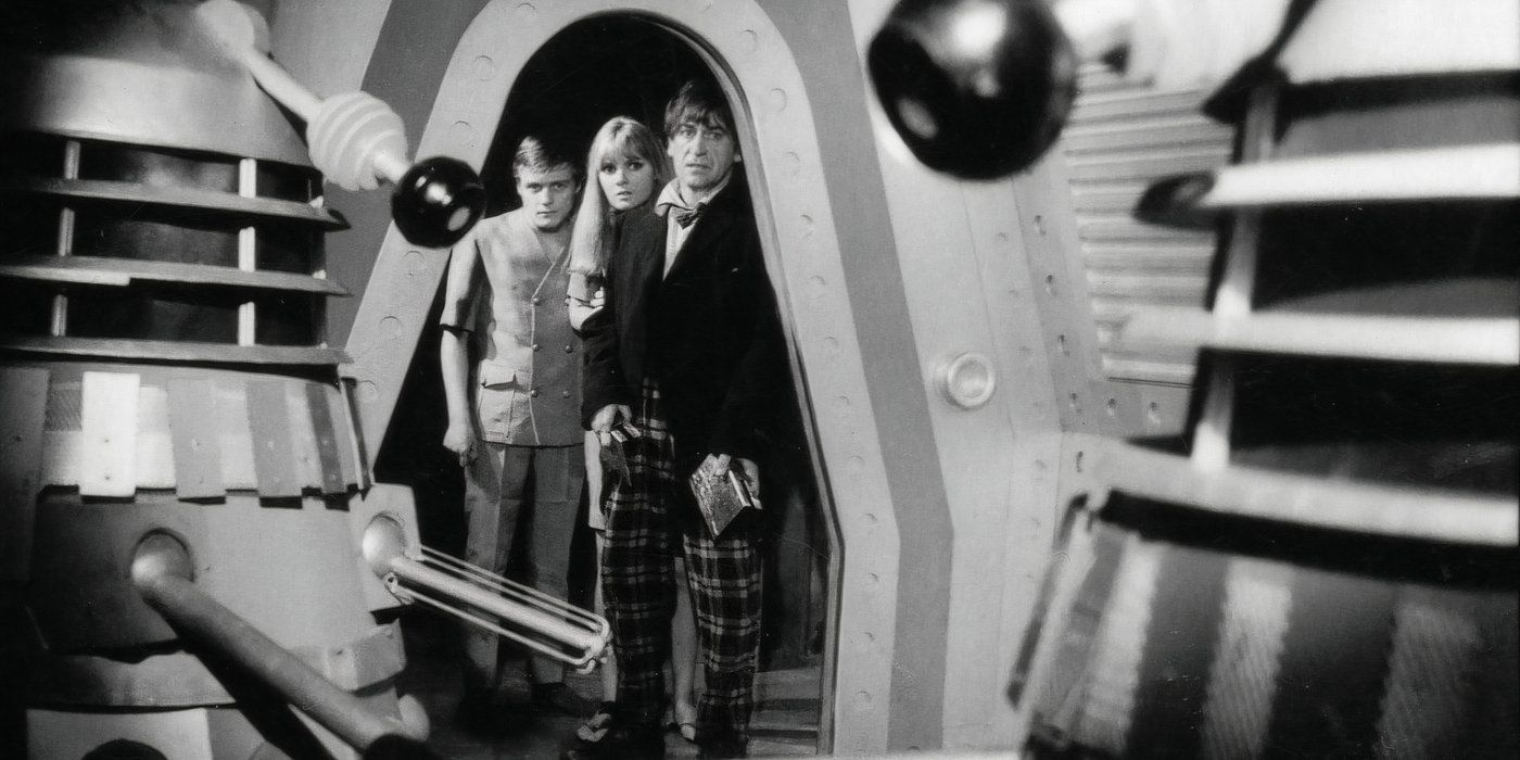 The Second Doctor, Polly, and Ben watching a Dalek in the Doctor Who serial "The Power of the Daleks."