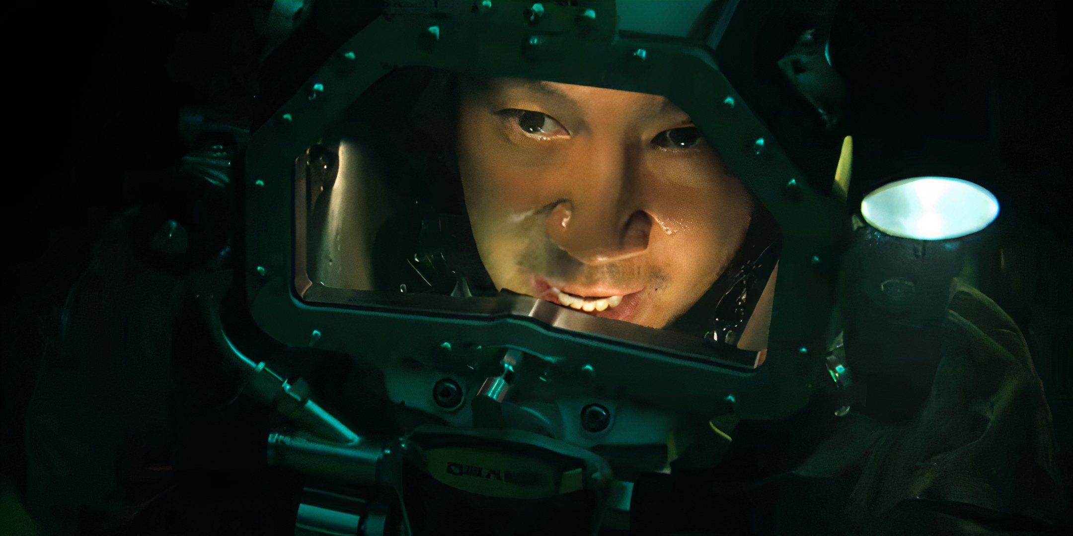 Simu Liu speaking to someone while in his deep-sea suit in Last Breath