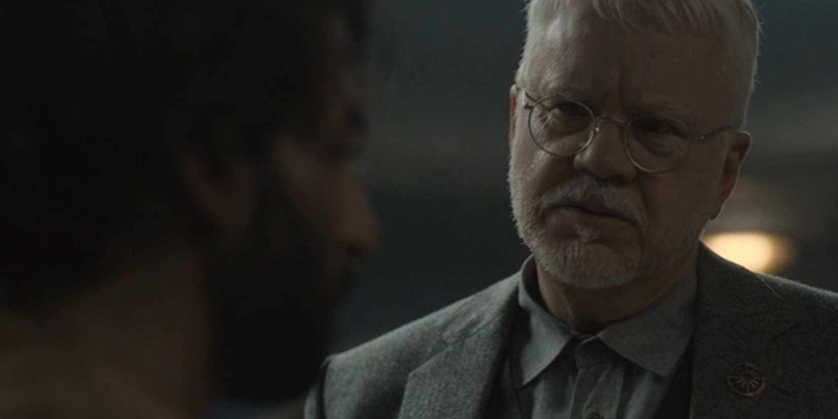 Tim Robbins as Bernard Holland in Silo looking at Avi Nash as Lukas Kyle