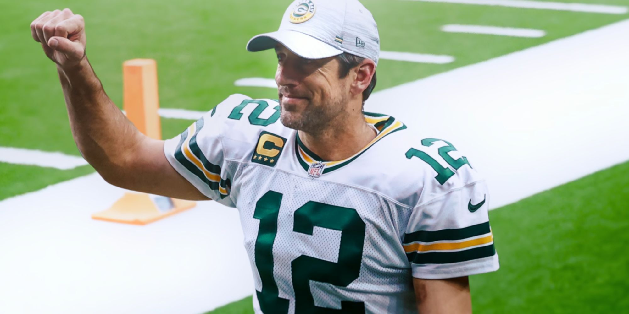 Aaron Rodgers as a Green Bay Packer smiling with his fist in the air in Aaron Rodgers: Enigma