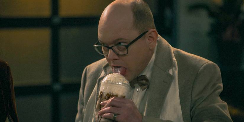 Mark Proksch as Colin Robinson enjoying the whipped cream on his coffee in What We Do in the Shadows Season 6 Ep 9