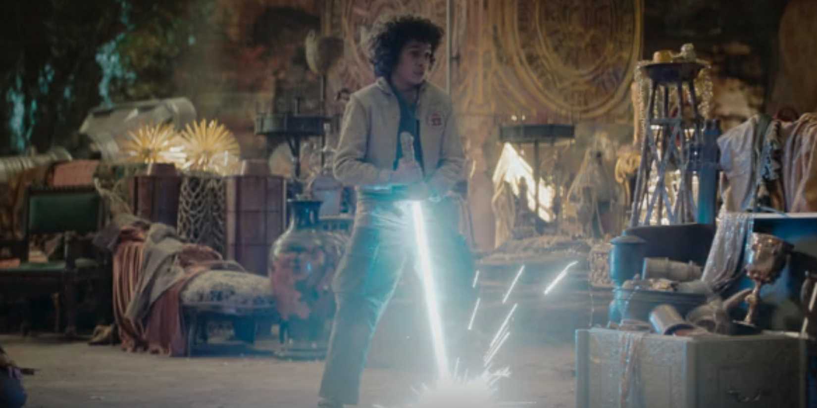 Wim holding a lightsaber upside in Skeleton Crew episode 5