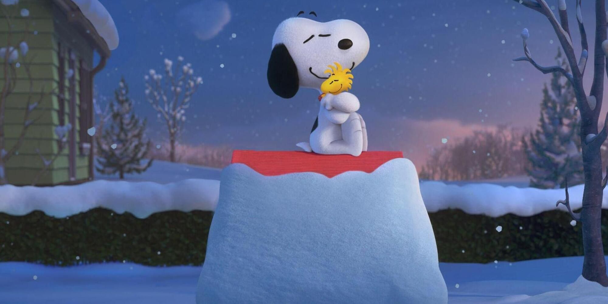 Snoopy and Woodstock hugging in the snow.