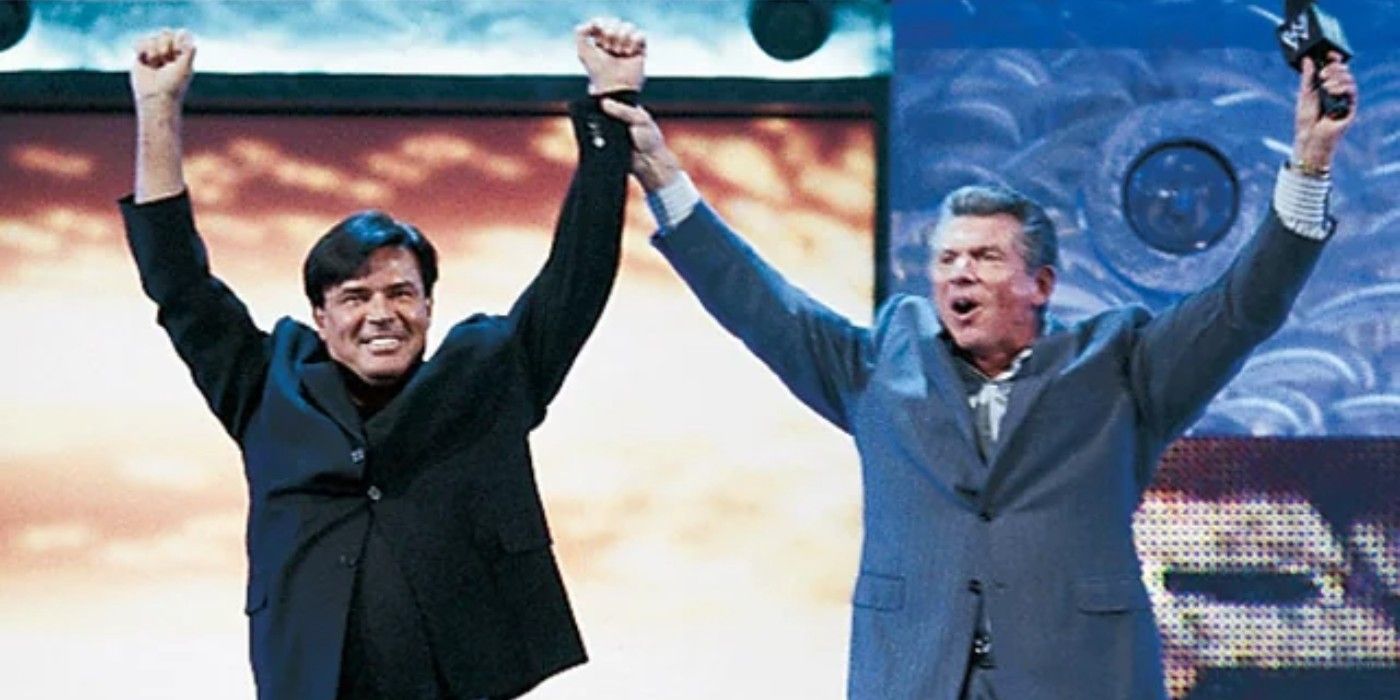 WWE Chairman Vince McMahon raises the arm of new Monday Night Raw General Manager Eric Bischoff in his debut