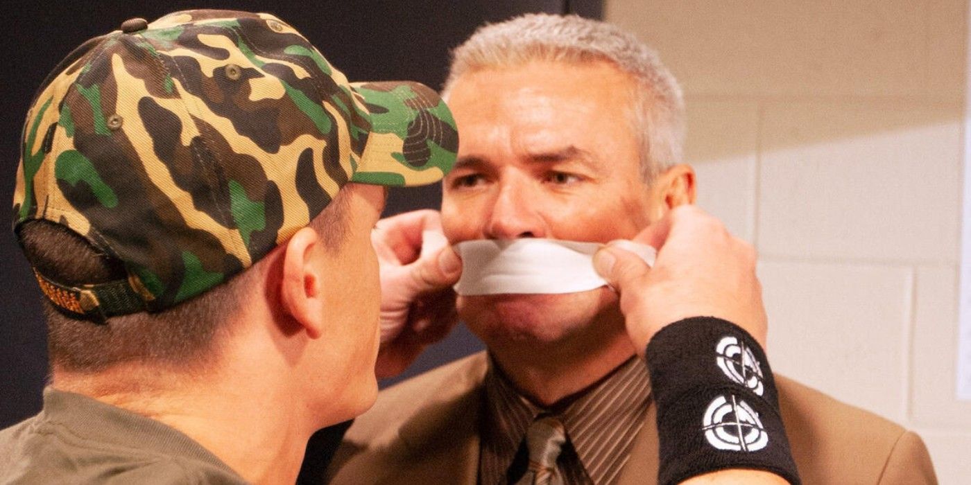 WWE Champion John Cena puts tape over the mouth of Eric Bischoff