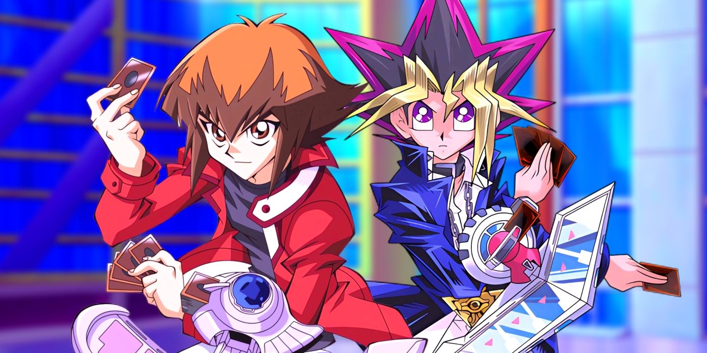 Yugi and Jaden standing side by side with their duel disks prepared for a duel. Behind them Domino City's plaza can be seen. 