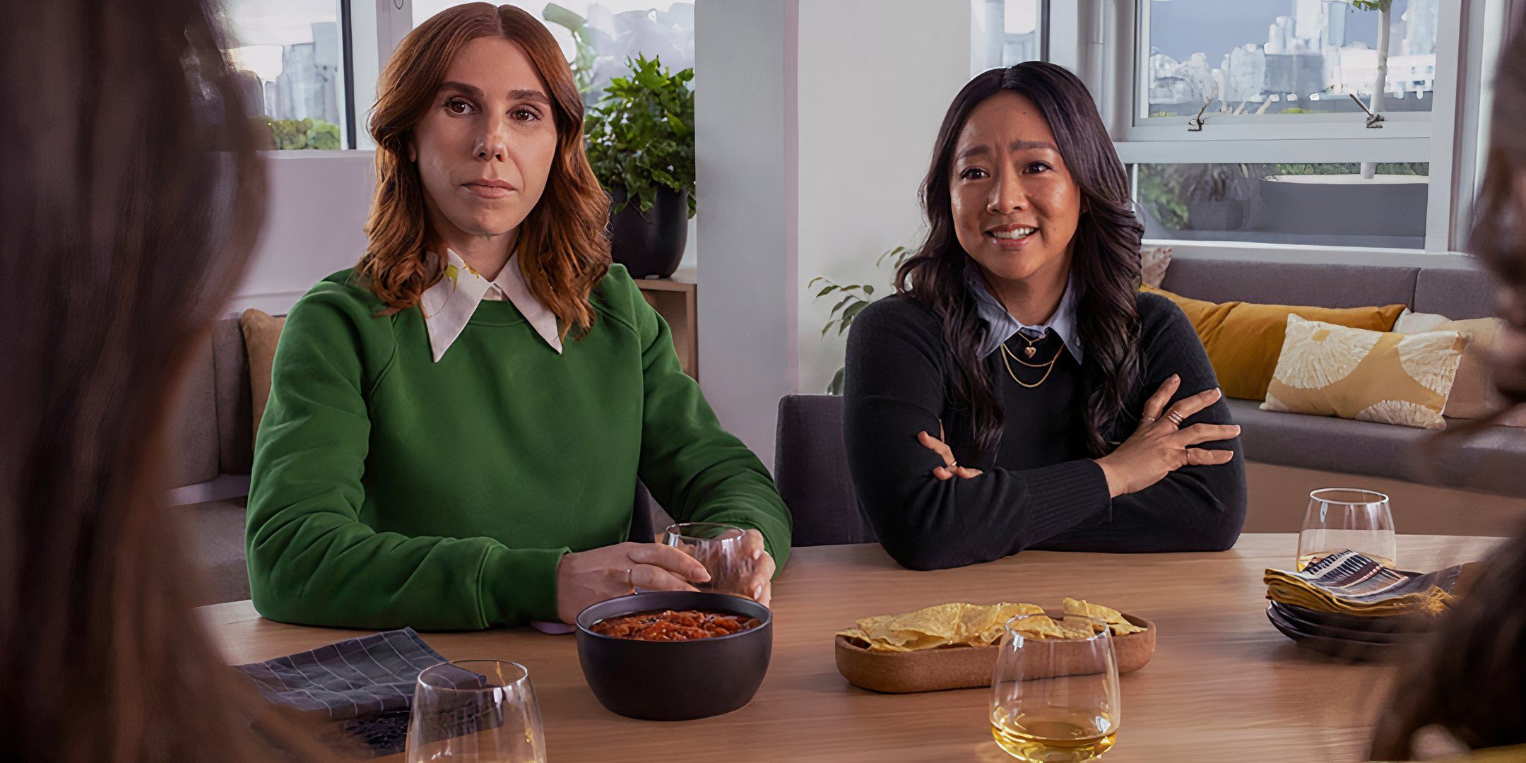 Zosia Mamet's AJ looking intently and Stephanie Hsu's Ruby smiling while talking to someone in Laid