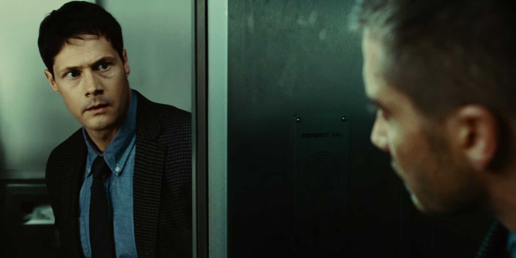 Jake Gyllenhaal as Colter Stevens in Source Code looking into a mirror and seeing Frédérick De Grandpré as Sean Fentress