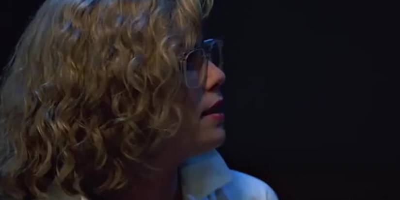 Charlie in dark room with glasses in Top Gun