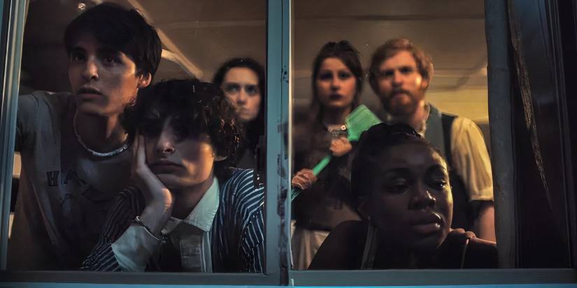 a group of teens standing around a window in Hell of a Summer