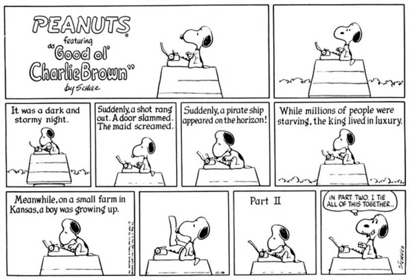 Snoopy writing on his typewriter on top of his doghouse.