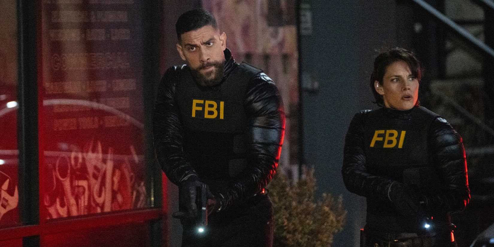 FBI OA and Maggie tiptoeing past a red window with flashlights out