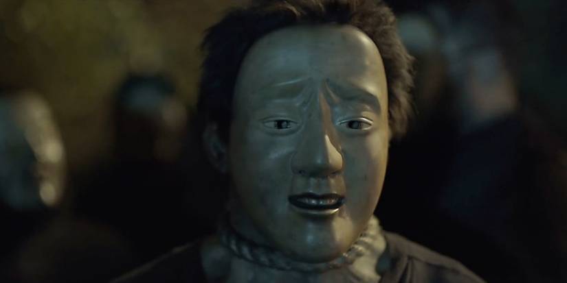 A man in a mask with a noose around his neck in The Fall.