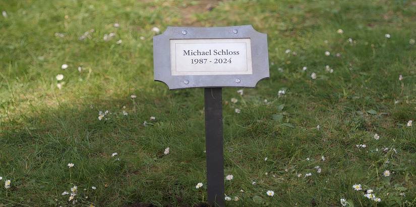 A plaque at a grave says Michael's name and lifespan in Peacock's Laid