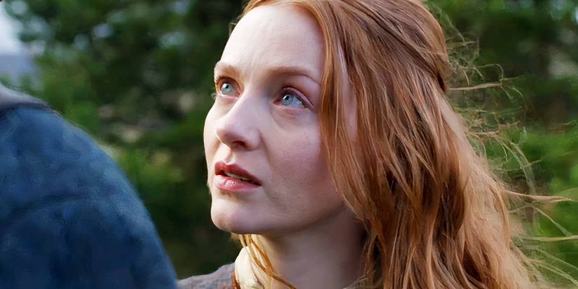 A redheaded woman looking longingly at a man in Outlander Blood of My Blood