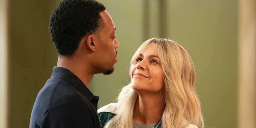 Kaitlin Olson's Dee Reynolds leaning in towards Gregory Eddie (Tyler James Williams) in the Abbott Elementary/It's Always Sunny In Philadelphia crossover episode.