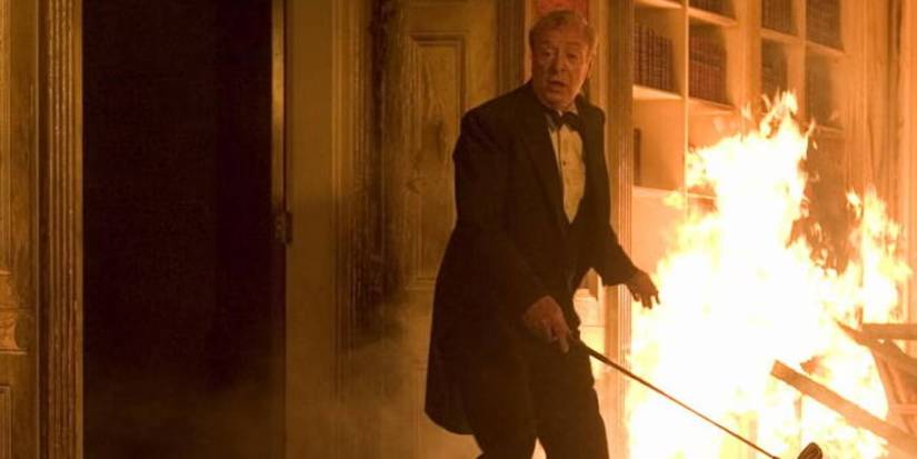 Alfred in burning Wayne Manor in Batman Begins