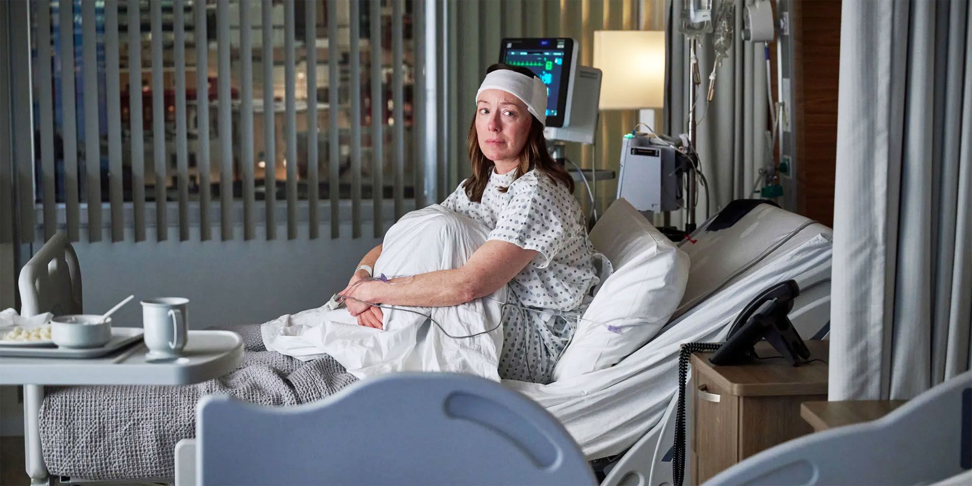 Amy Larsen (Molly Parker) in Doc episode 1, sitting on a bed with her head bandaged