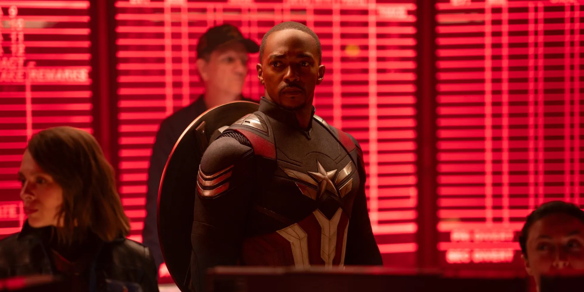 Anthony Mackie's Captain America stands in a room