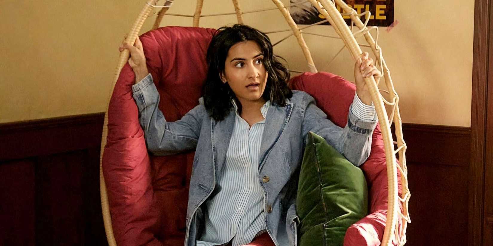 Bela (Amrit Kaur) sitting in a hanging chair in The Sex Lives of College Girls