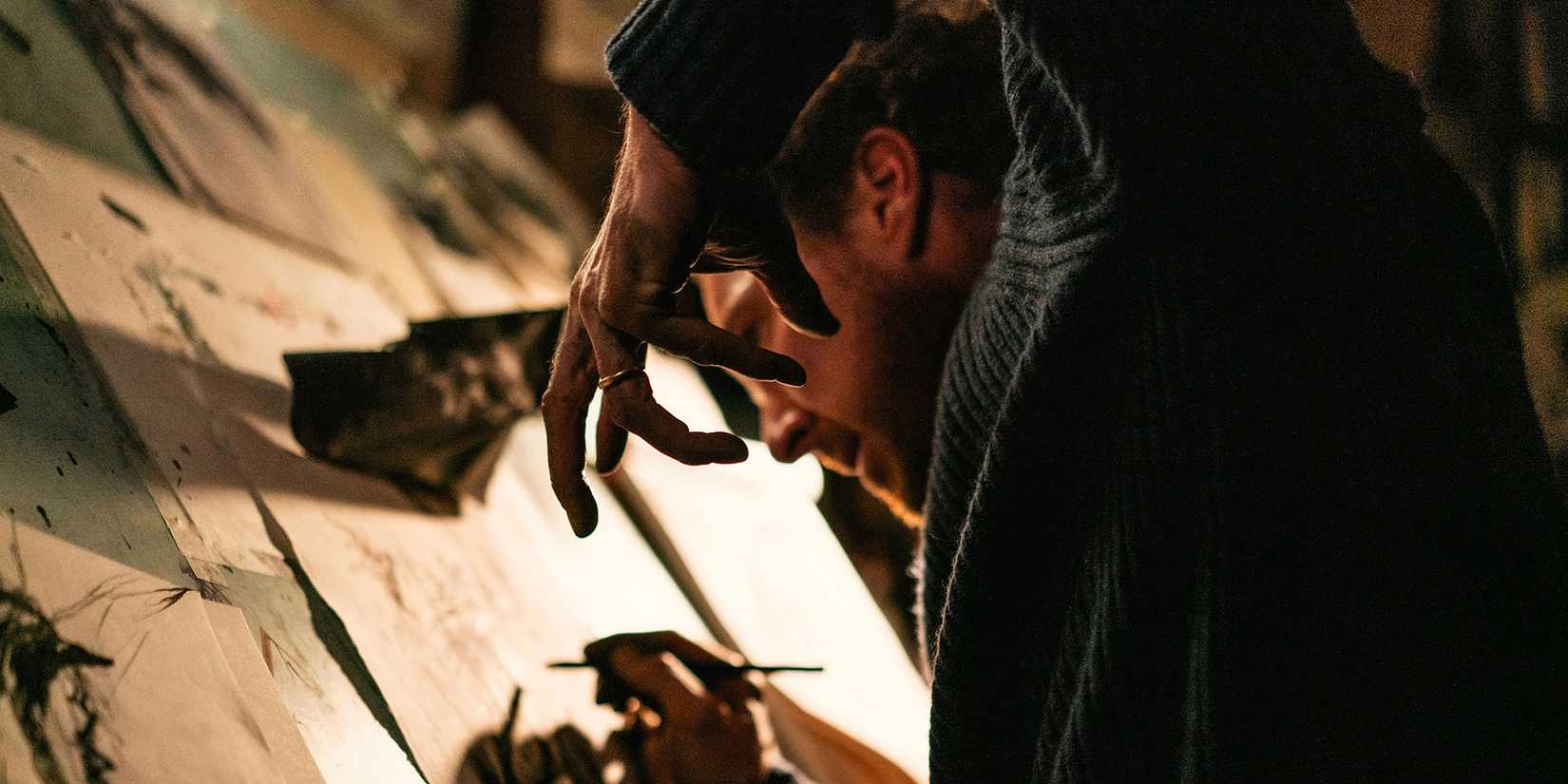 Benedict Cumberbatch with his arm in a weird position while drawing in The Thing with Feathers