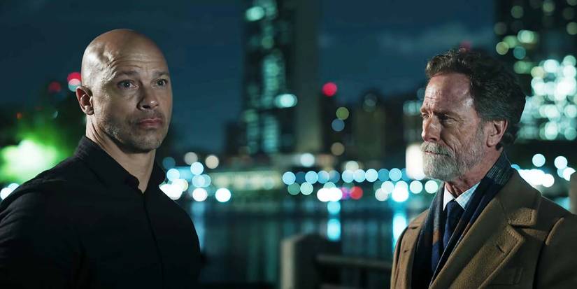 Berto Colon as Solomon standing next to Louis Herthum's Jacob in The Night Agent season 2 episode 8