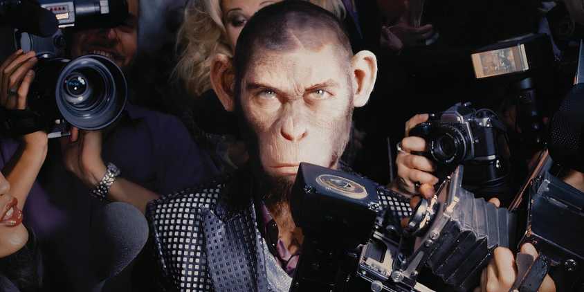 Robbie Williams as a chimpanzee surrounded by cameras in the Better Man poster