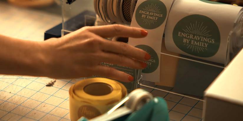 Emily (Cameron Diaz) reaching for a sticker that reads "Engravings by Emily" in Back in Action