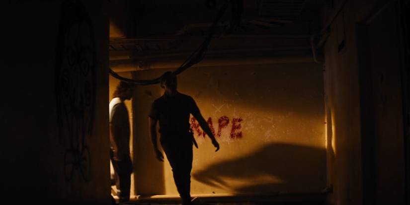 Billy the Saw puppet painted on a wall in Upgrade