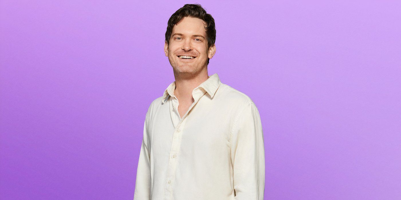 Love is Blind Season 8 Bradford Morgan in a cream shirt smiling during the photo shoot of the show