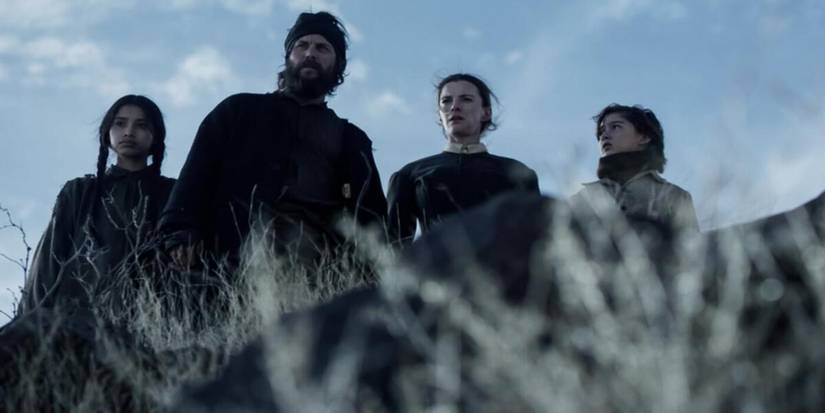 Low angel shot of four characters in American Primeval