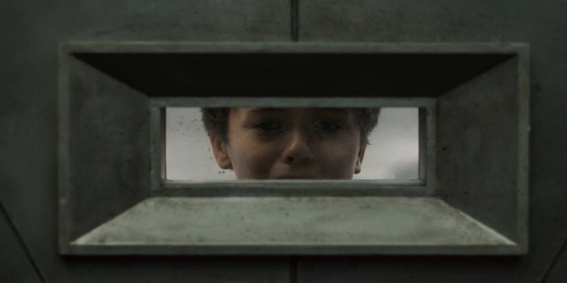Cameron Bell as young Solo in Silo season 2 episode 9