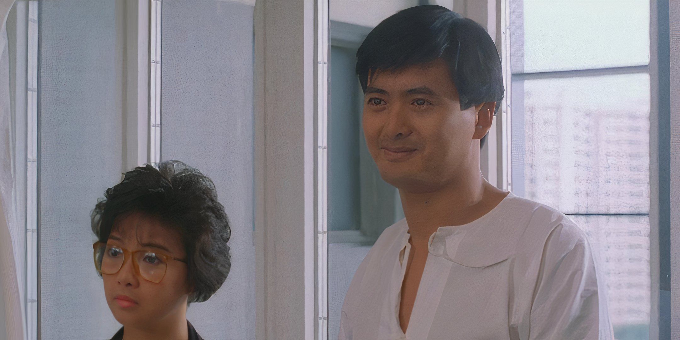 Chow Yun-Fat and Shirley Ng smile and stand next to one another.