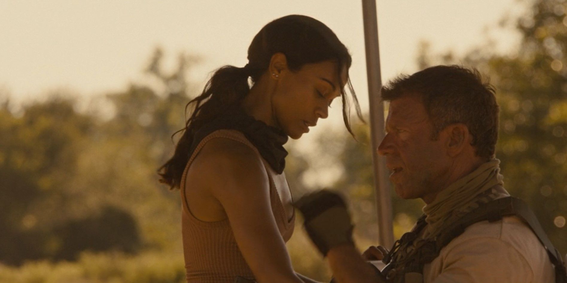 Joe (Zoe Saldana) and Cody (Taylor Sheridan) under a tent in Lioness season 2, episode 1