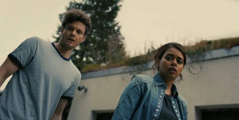 Megan Suri and Jack Quaid examine a car in Companion