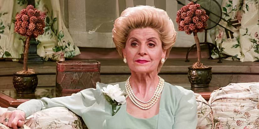 Concetta Tomei As Lynda Hansen sitting on a couch looking stern in Providence-1