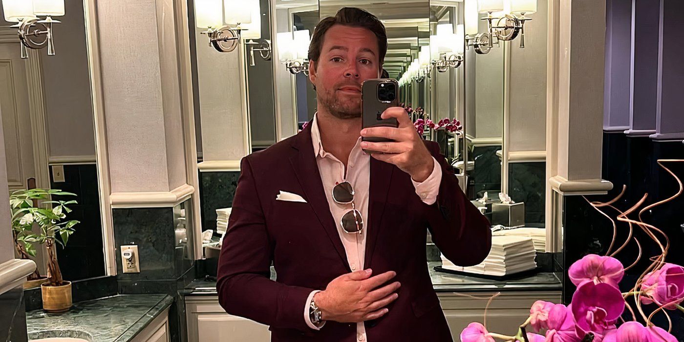 Love is blind season 8 David Bettenburg in a suit taking a mirror selfie.