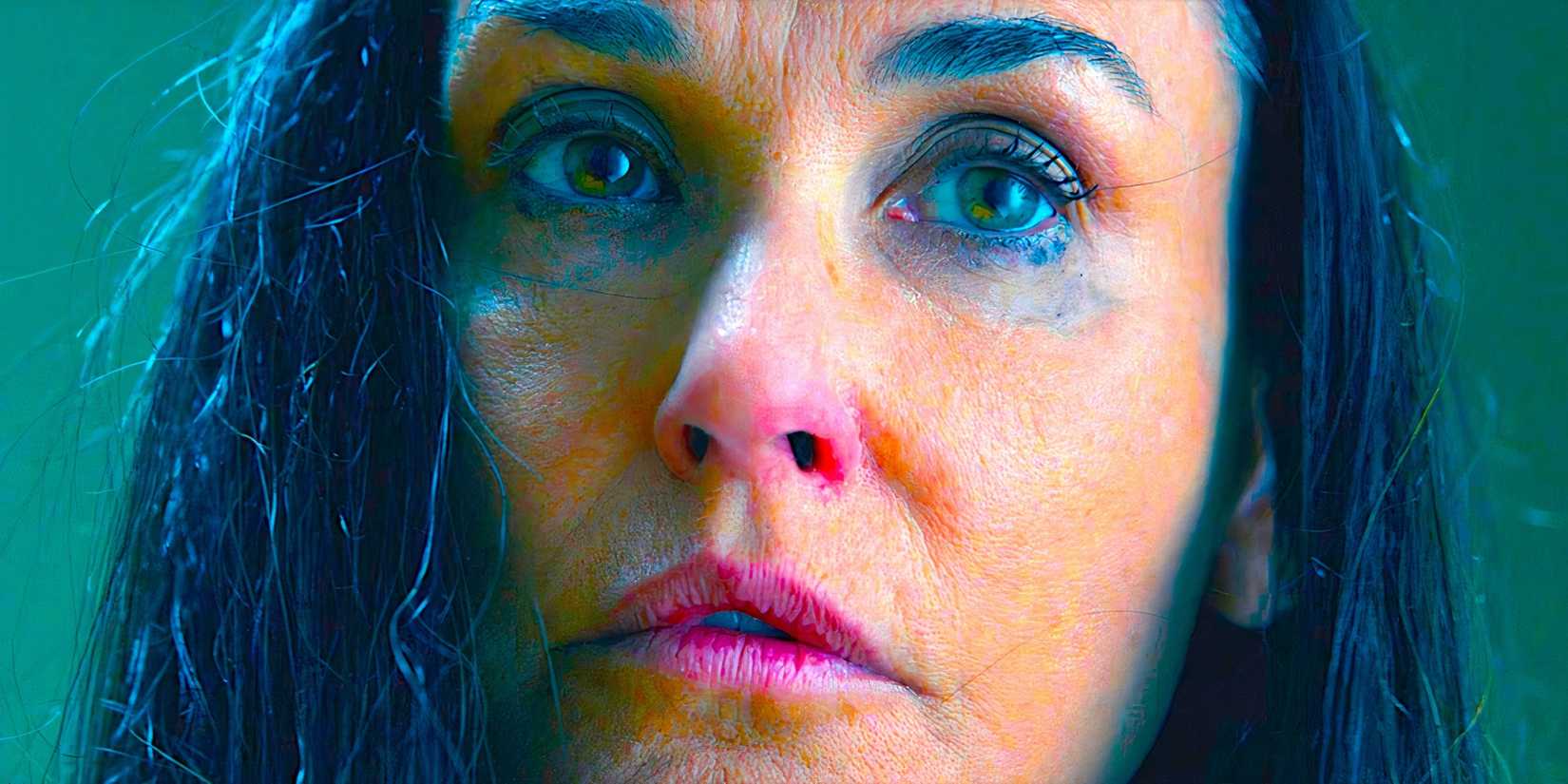Demi Moore gazing with bewilderment in a scene from The Substance