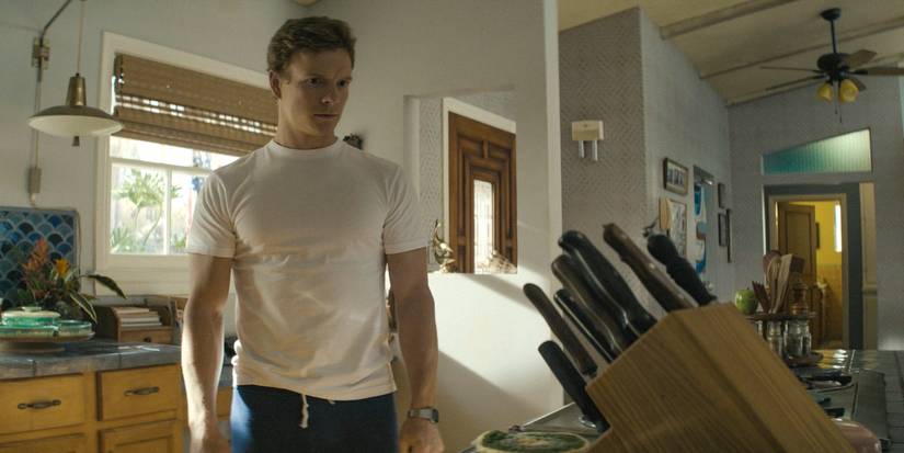 Dexter (Patrick Gibson), staring at the knives in the kitchen in Dexter: Original Sin Season 1 Ep 5