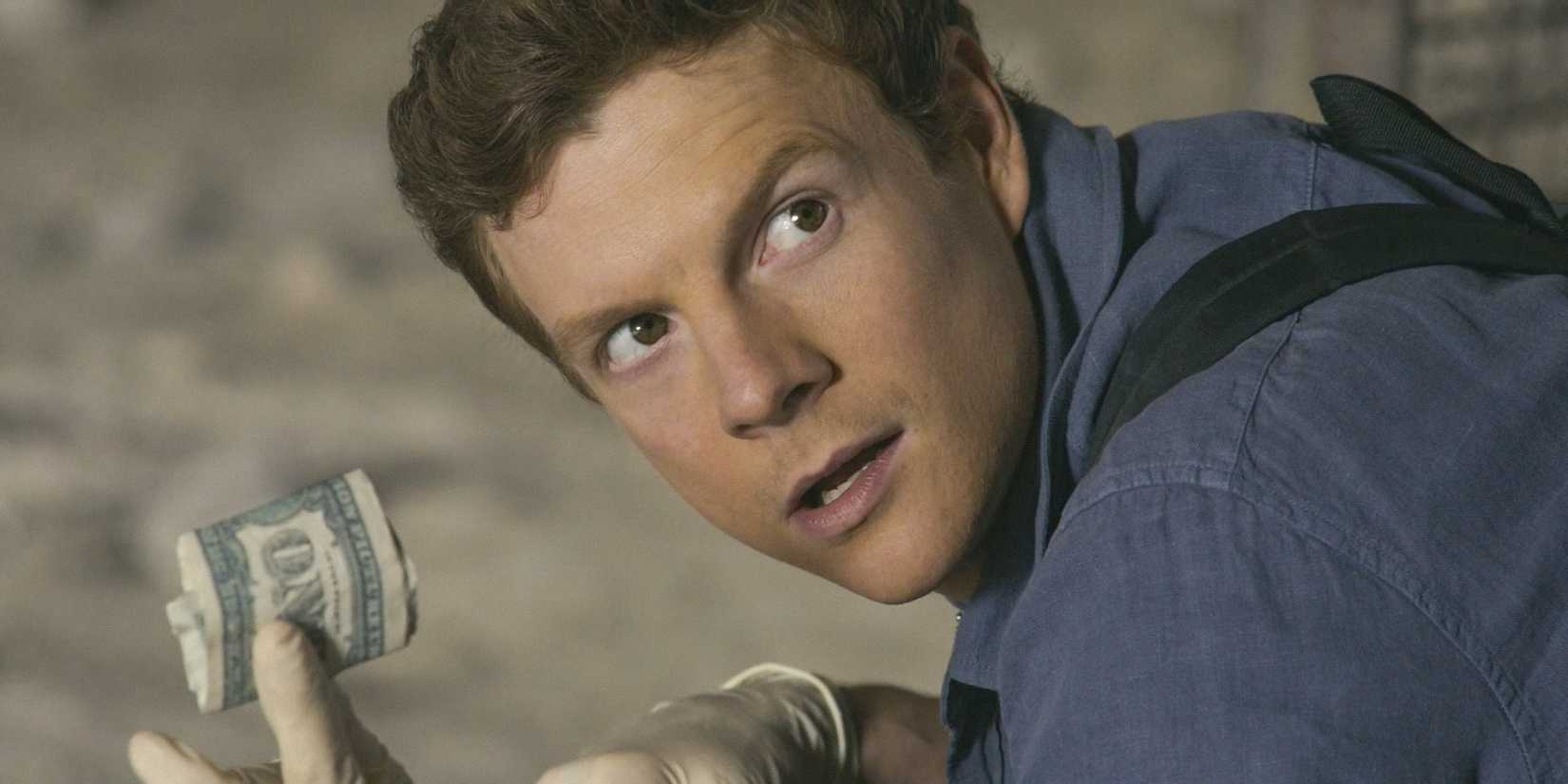 Dexter (Patrick Gibson) showing a bill found at the crime scene in Dexter: Original Sin Season 1 Ep 6
