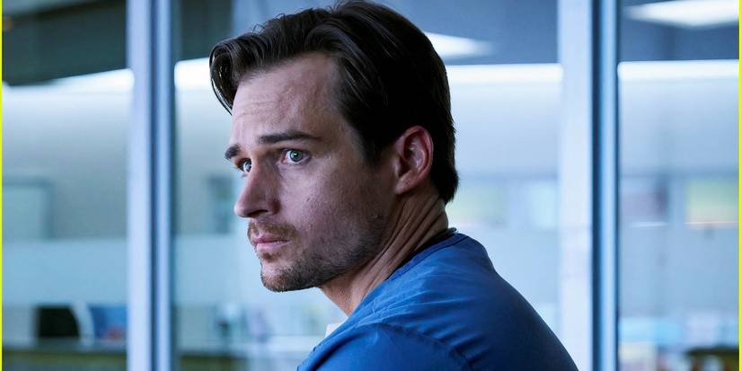 Dr. Heller looks over his shoulder with a concerned expression in Doc