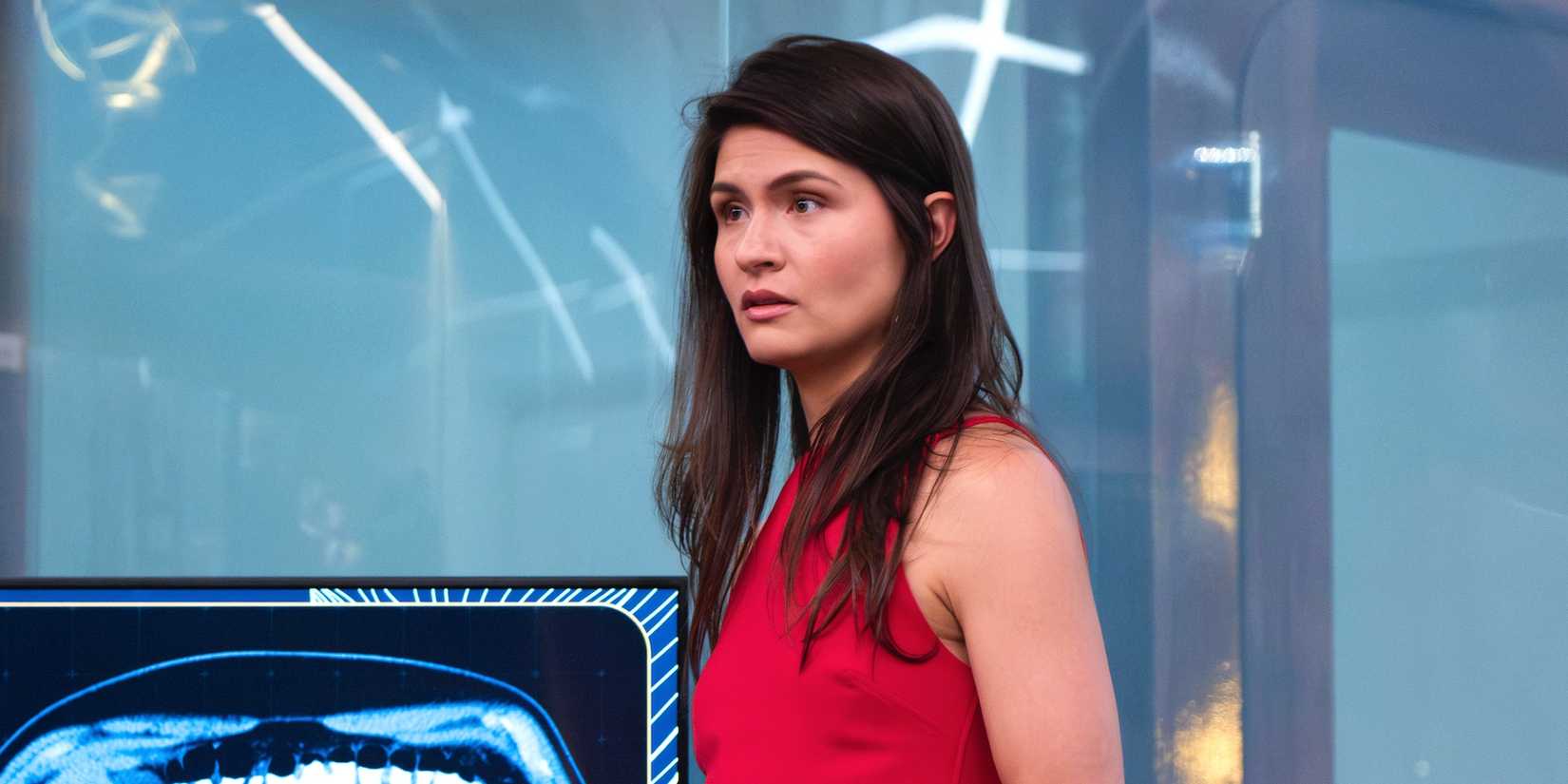 Phillipa Soo wearing a red dress as Avery Morgan in Doctor Odyssey