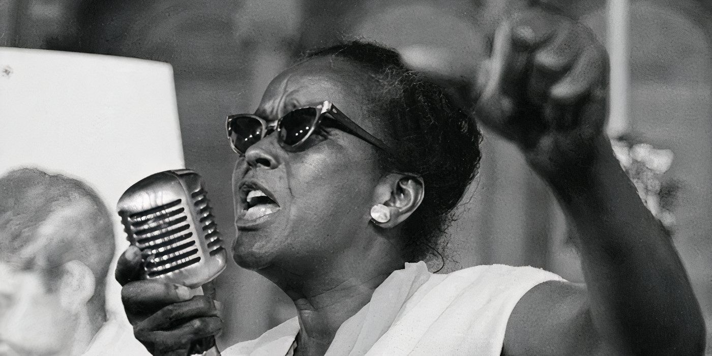 Ella Baker singing into a microphone