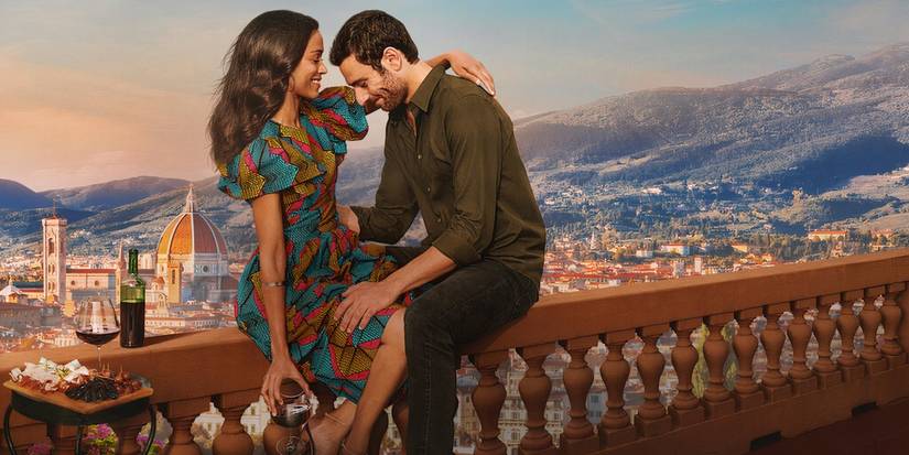 Zoe Saldana and Eugenio Mastrandrea cuddling on a balcony in Netflix's From Scratch